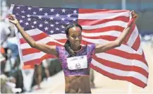  ?? PHOTOS BY RICH PEDRONCELL­I/THE ASSOCIATED PRESS ?? Dalilah Muhammad holds up the U.S. flag after she won the women’s 400-meter hurdles at the U.S. Track and Field Championsh­ips on Sunday.