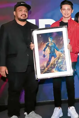  ??  ?? Treb Monteras (left) and James Reid show off an artist’s rendition of the new “Pedro Penduko”