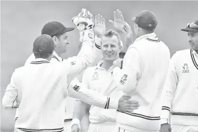  ??  ?? New Zealand’s Neil Wagner (C) celebrates Bangladesh’s Tamim Iqbal Khan being caught with teammates during day three of the second Test cricket match between New Zealand and Bangladesh at the Basin Reserve in Wellington on March 10, 2019. - AFP photo