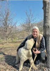  ??  ?? Hanene van Dyk and Dick, one of her Lagotto Romagnolo pack, in the orchard at Altima. PICTURE: ALLISON FOAT