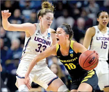  ?? AP/JESSICA HILL ?? Oregon guard Lexi Bando (right) yells to her teammates while being cut off by Connecticu­t forward Katie Lou Samuelson during the Bridgeport Regional final of the NCAA Women’s Basketball Tournament on Monday in Bridgeport, Conn. The Huskies never...