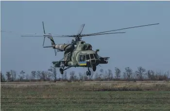  ?? PHOTOS: GETTY IMAGES ?? A Ukrainian Mi-8 helicopter flies low towards the front line in Ukraine’s Mykolaiv oblast. Some Ukrainian helicopter gunship units are relying on malfunctio­ning Soviet-era aircraft, rigged to fire a hodgepodge of Soviet and Western weapons.
