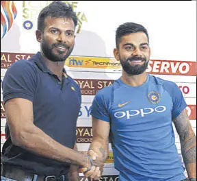  ?? AFP ?? Virat Kohli (R) shakes hands with Sri Lanka captain Upul Tharanga on Thursday.