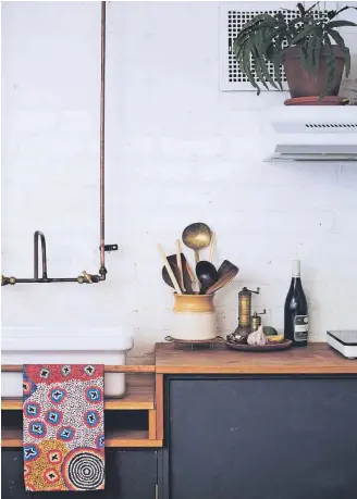  ??  ?? Above left: A brass crab picked up in Japan. Above: The small but well-functionin­g kitchen.