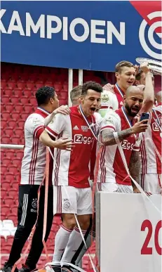 ??  ?? Dominant…Ajax celebrate lifting the trophy