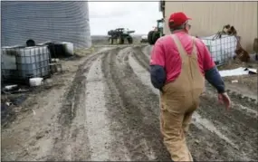  ?? THE ASSOCIATED PRESS ?? Blake Hurst, a corn and soybean farmer and president of the Missouri Farm Bureau, walks to the tractor shed on his farm in Westboro, Mo.