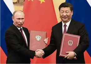  ?? AFP ?? First among equals: Putin and Xi had an official meeting before the Shanghai Cooperatio­n Organisati­on summit in Qingdao. Sloppy US policies have helped to build a growing China-Russia alliance for a full decade now.-