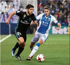  ?? — Reuters ?? I got this one: Real Madrid’s Marco Asensio (left) dribbling past Leganes’ Naranjo in the Spanish King’s Cup quarter-final first leg match at the Butarque Stadium on Thursday.