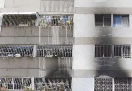  ?? AP ?? Signs of smoke cover the apartment complex where an armed drone crashed, causing a fire, in Caracas on Sunday.