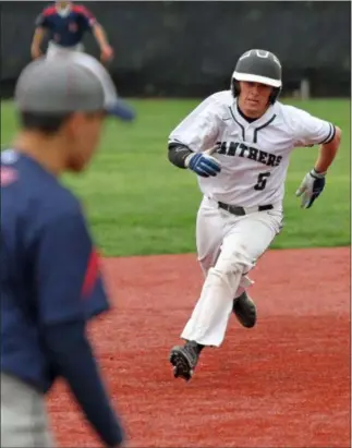  ?? RANDY MEYERS — FOR THE MORNING JOURNAL ?? Elyria Catholic’s Grant McClure runs the bases against Lincoln West on Monday May 13 at Oberlin College.