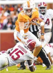  ?? STAFF PHOTO BY ROBIN RUDD ?? Tennessee’s Ethan Wolf tries to avoid the tackle of Alabama’s Ronnie Harrison after a reception in their 2016 game. Harrison was heavily recruited by Florida State and is looking forward to facing the Seminoles in September.