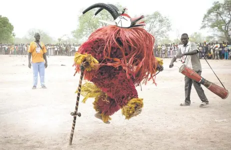  ?? — AFP photos ?? A traditiona­l mask dances during the Festimasq, the Festival des Masques in Pouni, Sanguie province.