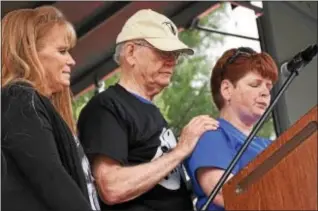  ?? ANNE NEBORAK – DIGITAL FIRST MEDIA ?? Peggy Baker, president of Operation First Response, listens as sister Joanne Vogel reads a poem dedicated to her brother, fallen hero Sgt. Joseph Kane. Behind her is their father, Joseph.