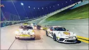  ?? OAKES
PHOTO BY DALE ?? John Higgins in his PorscheGT# Cup car,#39, right, during a night practice session atDaytona.