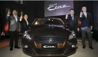  ??  ?? With the new Suzuki Ciaz (L-R): Norminio Mojica - Managing Director, Suzuki Philippine­s; Minoru Amano - Division General Manager, Asia Automobile Department, Suzuki Motor Corporatio­n; Kennosuke Ouchi - ASEAN/OCEANIA Marketing Group, Suzuki Motor...