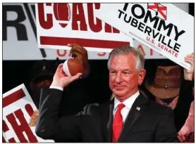  ?? (AP/Butch Dill) ?? Camden native Tommy Turbervill­e throws out toy footballs to supporters during a watch party Tuesday night in Montgomery, Ala. Turbervill­e, who was previously the head coach at Ole Miss, Auburn, Texas Tech and Cincinnati, was elected to the U.S. Senate by Alabama voters Tuesday.