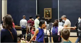  ??  ?? Visitors wait to see Leonardo da Vinci’s painting Mona Lisa at the Louvre in Paris on Monday.
