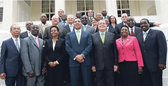  ?? FILE PHOTOS ?? Prime Minister Andrew Holness (centre) with his Cabinet ministers and state ministers after they were sworn in at King’s House in St Andrew last year.