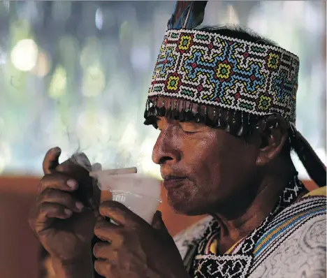  ?? PHOTOS: MARTIN MEJIA/THE ASSOCIATED PRESS ?? Shaman Pablo Flores prepares to drink ayahuasca during a session in Nuevo Egipto, a village in the Peruvian Amazon. Tourists in search of spiritual healing have embraced the drug, despite its troubled associatio­n with several deaths.