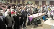  ?? AP/ADRIAN SAINZ ?? Attendees hold hands in prayer Tuesday in Memphis, at a rally honoring the legacy of slain civil-rights leader Martin Luther King Jr.