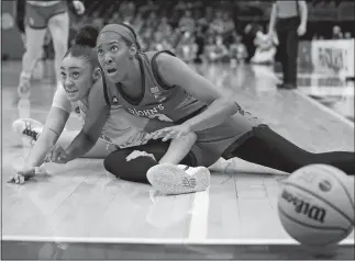  ?? MICHAEL CONROY/AP PHOTO ?? St. John’s forward Danielle Patterson, right, and North Carolina guard Destiny Adams (20) look to an official for a call as the ball goes out of bounds in the second half of a second-round game in the NCAA women’s basketball tournament on Saturday in Columbus, Ohio.