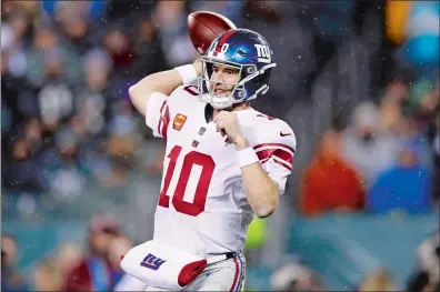  ?? MATT ROURKE/AP PHOTO ?? Eli Manning of the New York Giants passes during the second half Monday in Philadelph­ia. The veteran Manning started the game against the Eagles in place of the injured Daniel Jones and started out strong with 179 yards passing in the first half, but he completed just four passes for 24 yards in the second half in a 23-17 overtime loss.