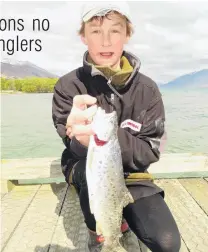  ?? PHOTOS: GUY WILLIAMS ?? Whopper . . . Seamus Hickey (14), of Christchur­ch, shows off one of the brown trout he caught off the Glenorchy wharf on Saturday. Right: Some of the fish caught.