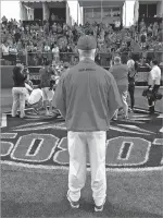  ?? WILL WEBBER NEW MEXICAN FILE PHOTO ?? UNM baseball coach Ray Birmingham looks on as his team poses with its fans after winning the 2016 Mountain West Conference Tournament championsh­ip.