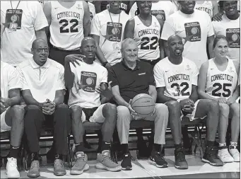  ?? GAVIN KEEFE/THE DAY ?? Former UConn men’s and women’s basketball players gather for a team photograph Friday at Mohegan Sun Arena, where they participat­ed in the Jim Calhoun Charity All-Star Game.