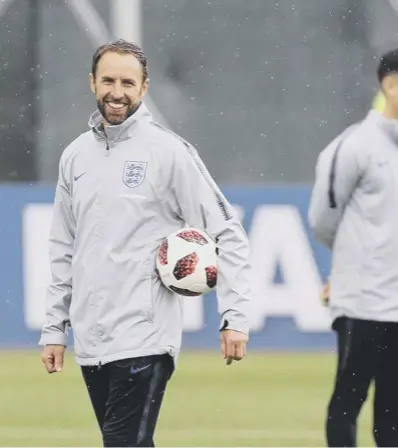  ??  ?? 0 The morning after the night before: Gareth Southgate was all smiles during England’s training session at Spartak Zelenogors­k Stadium as he prepares for the quarter- finals.