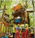  ?? Foto: dpa ?? Mitarbeite­r von RWE stehen vor Baum häusern von Umweltakti­visten.