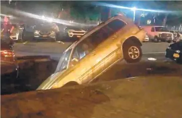  ?? JAMIE WEBB / @JAMIEDWEBB VIA TWITTER ?? Toyota SUV plunged into a sinkhole on Second St. near Avenue A late Saturday or early Sunday, police said. Local sewage backups that have flooded basements in the area were blamed.