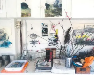  ??  ?? Louesa Roebuck’s work studio in Ojai, Calif., is adorned with some of her monotype studies, a few pieces by friends and peach blossoms. Provided by Louesa Roebuck