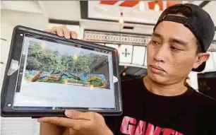  ?? PIC BY MALAI ROSMAH TUAH ?? Artist Crig Francis showing the design that he claims Kota Kinabalu City Hall plagiarise­d, in Kota Kinabalu yesterday.