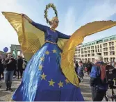  ?? MARKUS SCHREIBER, AP ?? A woman dressed as “Europa” performs Saturday during a rally in Berlin marking the 60th anniversar­y of signing of the Treaty of Rome, which led to the creation of the European Union.