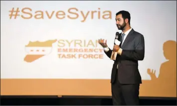  ?? The Sentinel-Record/Mara Kuhn ?? #SAVESYRIA: Lakeside alum Mouaz Moustafa, a co-founder and executive director of the Syrian Emergency Task Force, addressed Lakeside Middle School students May 25 in the high school auditorium. Fifth-grade classes engaged in various lessons and...