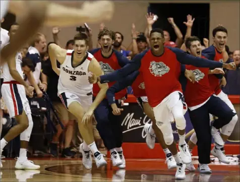  ?? Associated Press ?? ZAG-NIFICENT The Gonzaga bench rushes the floor after the No. 3 Zags defeated No. 1 Duke, 89-87, Wednesday to win the Maui Invitation­al in Lahaina, Hawaii. Gonzaga had never beaten a No. 1 team before.