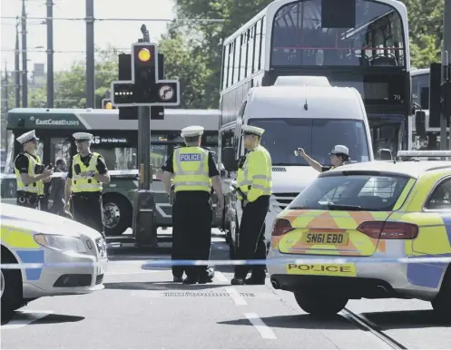  ??  ?? 0 Traffic police at the scene where a cyclist was fatally injured after being hit by a minibus