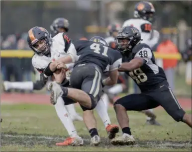  ?? JOHN BLAINE — FOR THE TRENTONIAN ?? Woodrow Wilson quarterbac­k Nick Kargman (2) is tackled by Burlington Twp.’s Mike Feoli (41) and Jalyn Blackwell (48) during the South Jersey Group III final on Saturday afternoon.