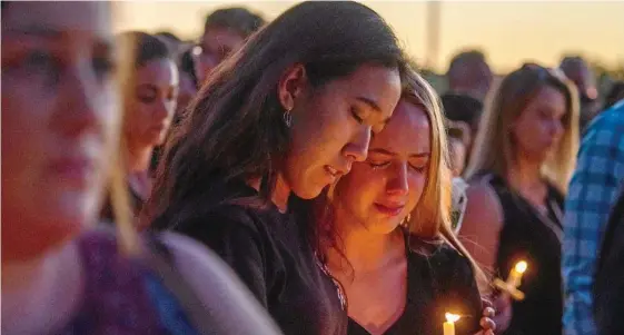  ?? PHOTO: EPA/GIORGIO VIERA ?? LIGHTING UP: Community members take part in a candleligh­t vigil at Pine Trails Park, Parkland, Florida, to honour victims of a mass shooting that took place at Marjory Stoneman Douglas High School on February 14 that left 17 dead.