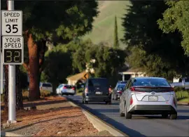  ?? PHOTO BY JOSEPH GEHA ?? A car drives past a flashing speed feedback sign on Paseo Padre Parkway in Fremont on Monday. The city is planning to spend about $150,000to buy 30more of the signs.