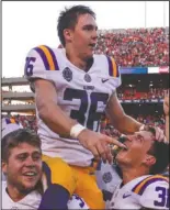  ?? The Associated Press ?? GAME-WINNER: LSU placekicke­r Cole Tracy (36) is hoisted on the shoulders of his teammates Saturday after kicking the winning field goal to defeat Auburn, 22-21, in Auburn, Ala.