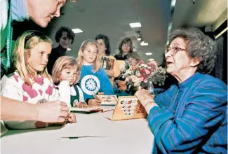  ?? VERN FISHER/MONTEREY HERALD ?? Beverly Cleary signs books at the Monterey Bay Book Festival in 1998 in Monterey, California. The beloved children’s author, whose characters Ramona Quimby and Henry Huggins enthralled generation­s of youngsters, died March 24. She was 104.