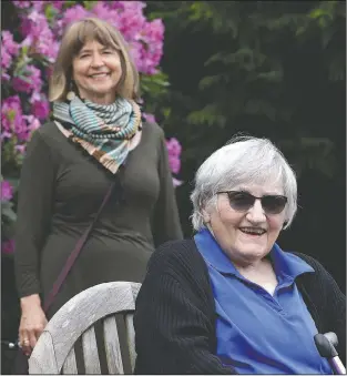  ?? (AP/Elaine Thompson) ?? Jessie Cornwell, a resident of the Ida Culver House Ravenna (right) poses for a photo with the Rev. Jane Pauw in Seattle. Cornwell tested positive for the coronaviru­s but never became ill, and may have been infectious when she shared a ride to Bible study with Pauw, who later got sick with covid-19.