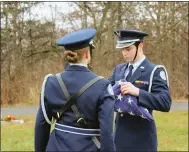  ?? PHOTO COURTESY OF NPHS JROTC ?? North Penn High School’s Air Force Junior ROTC cadets ceremonial­ly fold an American flag at a “Wreaths Across
America” event.