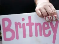  ?? Associated Press ?? A Britney Spears supporter holds a sign outside a court hearing concerning the pop singer's conservato­rship at the Stanley Mosk Courthouse, Wednesday in Los Angeles.