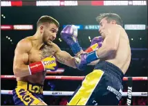  ??  ?? In this April 12, 2019 file photo, Vasiliy Lomachenko (left), from Ukraine, hits Anthony Crolla, from Britain, during a WBA and WBO lightweigh­t title
boxing match in Los Angeles. (AP)