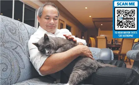  ?? ?? Mayor Tom Tate has a hissstory with cats. Here he is in 2012 telling a tail to family moggy Mowie.