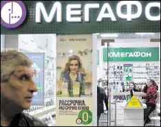  ?? IVAN SEKRETAREV / ASSOCIATED PRESS ?? People inside a Megafon mobile phones shop Saturday in Moscow. A top Russian mobile operator said Friday it had come under cyberattac­ks that appeared similar to those that have crippled some U.K. hospitals.