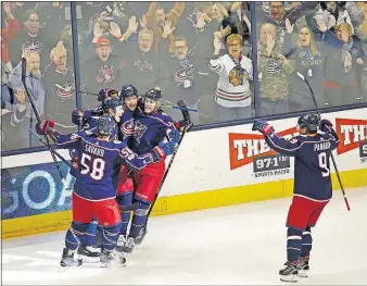  ?? [FRED SQUILLANTE/DISPATCH] ?? Blue Jackets players celebrate a goal by top-line right wing Josh Anderson, second from right in scrum, as top-line left wing Artemi Panarin skates in to join the festivitie­s during a win over Anaheim. Also in the scrum is No. 1 center Pierre-Luc Dubois, right.